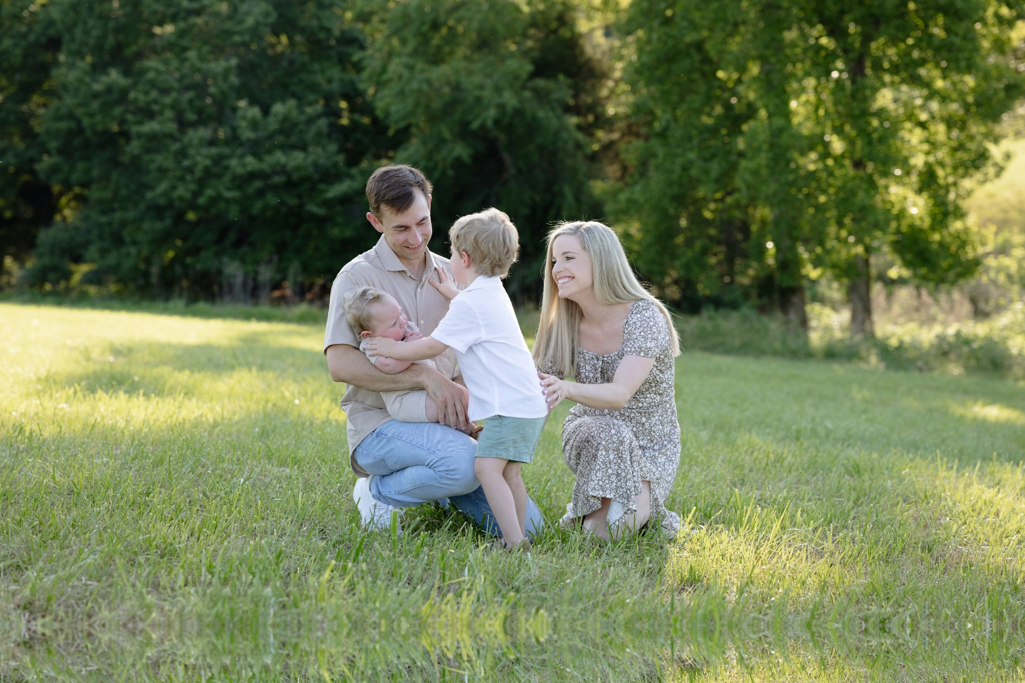 Chris Herring and Dr. Hannah Thompson standing outdoors with their two sons