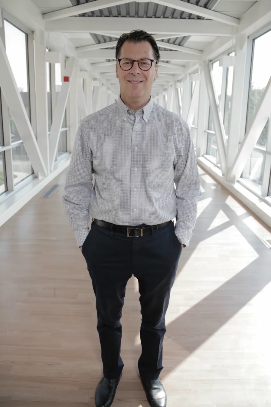 Brian Hoeflinger standing in a hospital skywalk